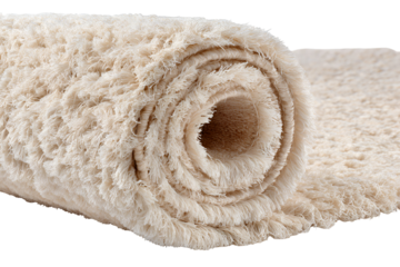 Rolled up beige shaggy rug with textured surface on black background