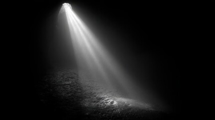 Fototapeta premium Dramatic Light Beam in Dark Cave Black and White