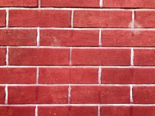Closeup of a red brick wall with white mortar, creating a textured background pattern