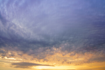Beautiful colorful evening or morning fluffy clouds in sky. Blue and yellow cloudscape at sunset or sunrise. Nature background.