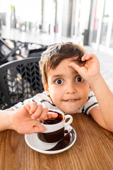 Surprised Boy Looking at a Delicious Cup of Hot Chocolate