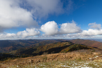Panoramic view of autumn Carpathian mountains under cloudy sky