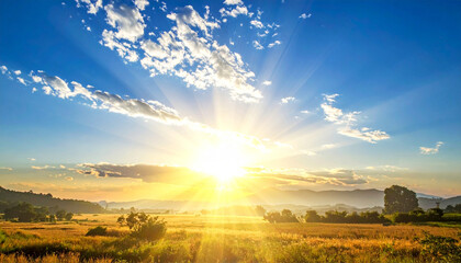 Scenic sunset with sun rays against bright blue sky