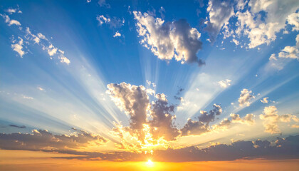 Scenic sunset with sun rays against bright blue sky
