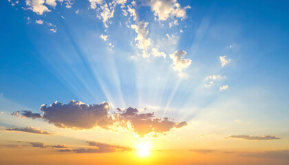 Scenic sunset with sun rays against bright blue sky