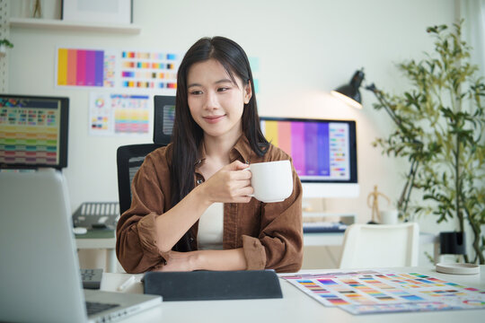 Creative professional taking a short break with coffee while working on design project at modern office. - Powered by Adobe