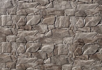 External wall covering made of irregular shaped brown gray stones rocks. Background and texture. Full frame.