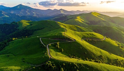 Green Mountains Under Sunlight Aerial View of Lush Peaks and Valleys Dramatic Landscape with Winding Road Scenic Beauty Golden Hour Hues
