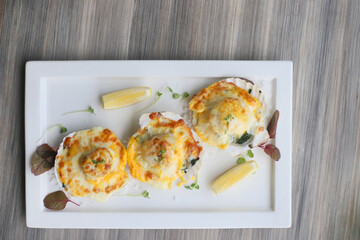 Delicious baked scallops dish presented on a rectangular plate