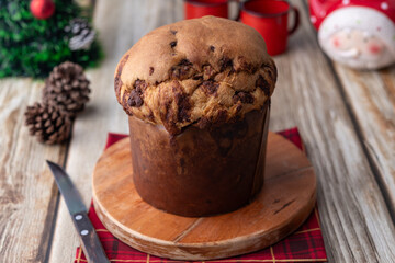 Chocotone, traditional italian cake panettone with chocolate chips over wooden table