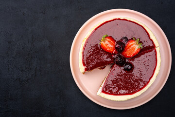  Cheesecake with strawberry on black background