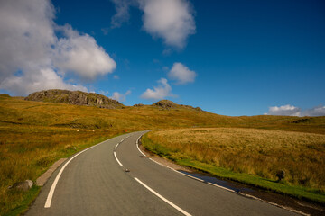 Curving Mountain Road Through Golden Hills in Snowdonia, Wales