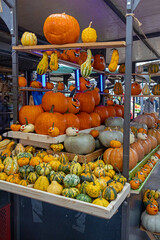 Halloween pumpkins sold outside on a local market stall corner