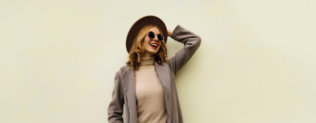 Beautiful stylish happy young woman, fashionable girl smiles posing on white studio background