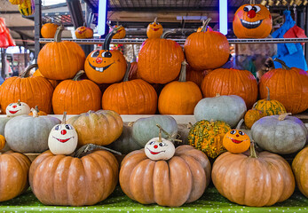 Traditional pumpkins Halloween trinkets decorated with spooky and festive elements on local market stall