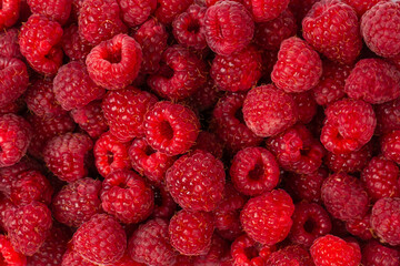 Raspberry in plastic container isolated on white background.