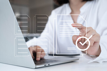 Businesswoman using laptop with digital document icons and check mark overlay, representing document approval, paperless workflow, cloud computing, e-signature, and digital transformation.