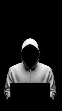 Anonymous person hoodie laptop dark room hacker working late night