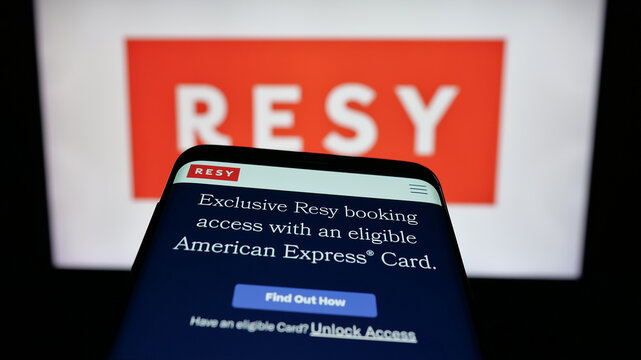 Stuttgart, Germany - 10-18-2025: Mobile phone with website of US restaurant reservation company Resy on screen in front of logo. Focus on top-left of phone display.