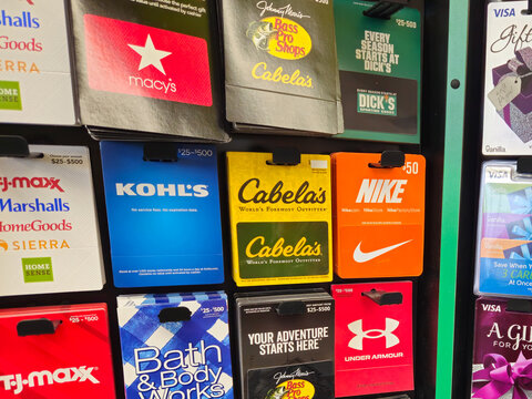 A collection of guft cards on retail display, including Macy's, Bass Pro Shops, Cabela's, Dick's Sporting Goods, Bath & Body Works, TJ Maxx, Under Armour, Kohl's, Nike, and Visa (October 21, 2025).
