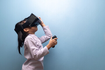 Little girl using VR headset and controller exploring immersive virtual reality world, concept of metaverse, digital learning, and future technology for children.