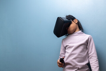 Little girl using virtual reality headset exploring immersive metaverse and futuristic digital learning experience, concept of innovation and VR education for children.