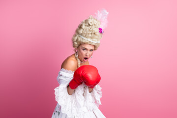 Graceful aristocratic woman wearing vintage costume with boxing gloves, blending baroque fashion...
