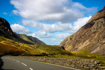 Mountain pass road through rocky valley, Snowdonia National Park, Wales
