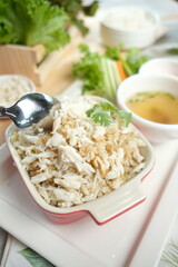 A delicious plate of crab meat with rice, a culinary delight. The dish is accompanied by a soup and fresh vegetables, offering a balanced and flavorful meal