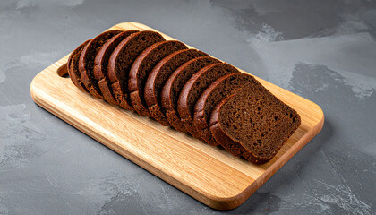 An overhead view of overlapping rye bread slices on a wooden board