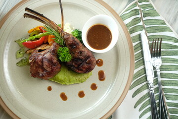 Gourmet Lamb Rack with Vegetables and Sauce, Close-Up Shot