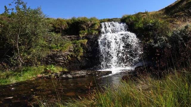 Waterfall in norway during summer hike, slow motion