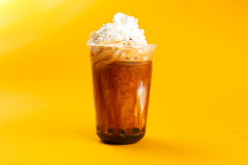 Bubble tea on a yellow background.