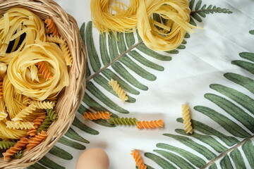 Assortment of pasta displayed in basket and table decor