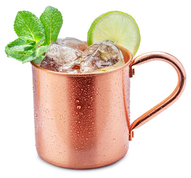 Сopper cup with Moscow mule drink decorated with lime and mint leaves white background. Clipping path.