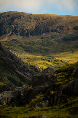 Fototapeta premium Rocky hillside and distant mountain slopes in Snowdonia, Wales