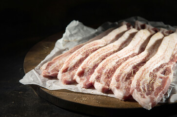 raw pork belly on a wooden board