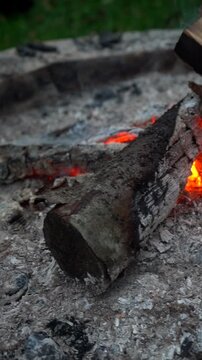 Firewood burns in the fire. The atmosphere is relaxing by the fire.