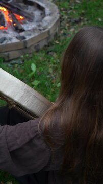 A dark-haired girl plays a large tambourine. The atmosphere is one of mystical music and ritual.