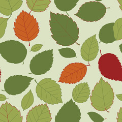 Seamless pattern of various green, orange, and red leaves scattered on a light green background.