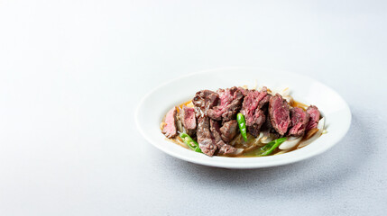 Meat tataki with vegetables on a plate