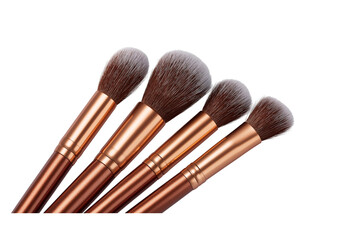 Four makeup brushes with bronze handles isolated on a transparent background