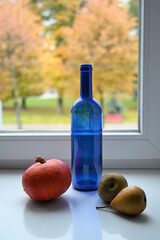still life with a blue bottle near the window	
