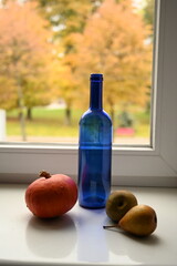 still life with a blue bottle near the window	
