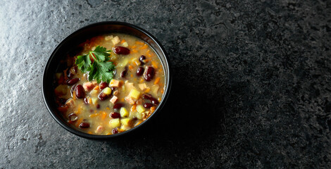 Red bean soup with potatoes, tomatoes, paprika, carrot, and bacon.