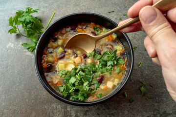 Red bean soup with potatoes, tomatoes, paprika, carrot, and bacon.
