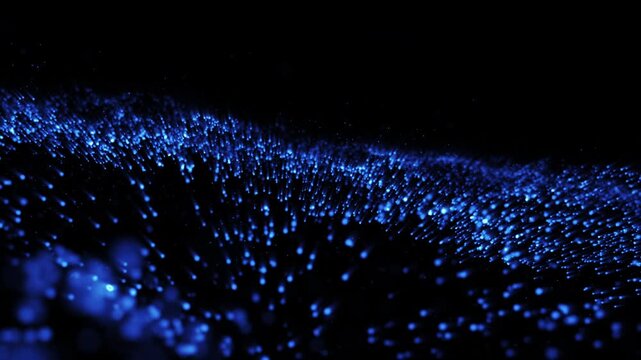 Abstract particle background in motion. Beautiful transition with real blue particles flying in wind on black background, shot with depth of field. blue dot dust bokeh.