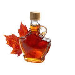 A bottle of amber colored liquid with a yellow cap sits on top of a pile of red