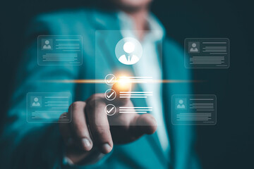 Businessman selecting digital profile with checklist icons, symbolizing human resource management, recruitment process, and employee evaluation in modern digital business technology.