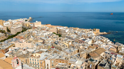 Aerial view of houses and buildings in the historic center of Trapani, Sicily, Italy. It is a beautiful city overlooking the Mediterranean Sea, with the sea stretching to the horizon.